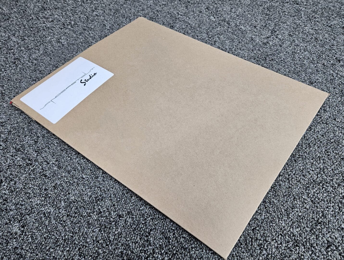 Manila envelope with label on gray carpet